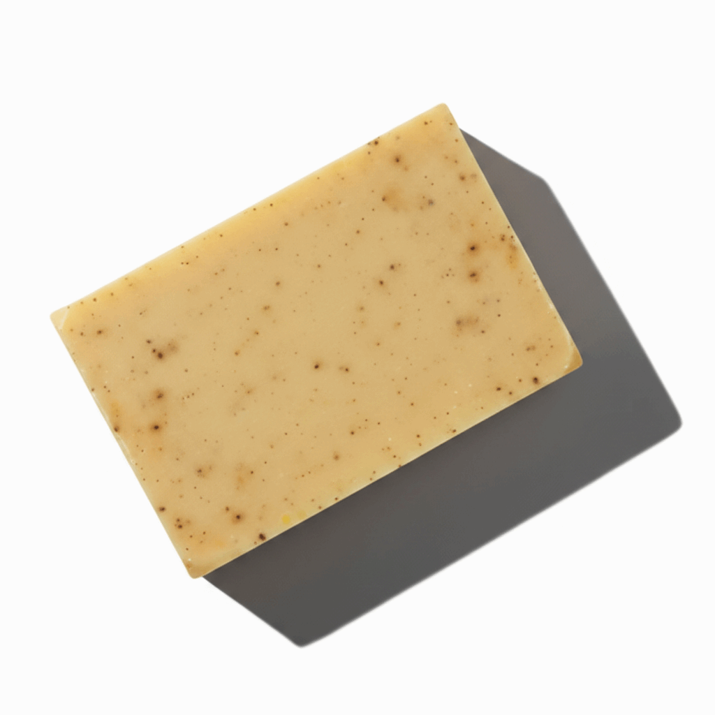 LG Apothecary Co Bay Runner Botanical Bar Soap styled flat lay on white background, showcasing clean rectangular shape and subtle dark botanical flecks.
