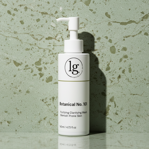 White skincare bottle with pump on a textured green background