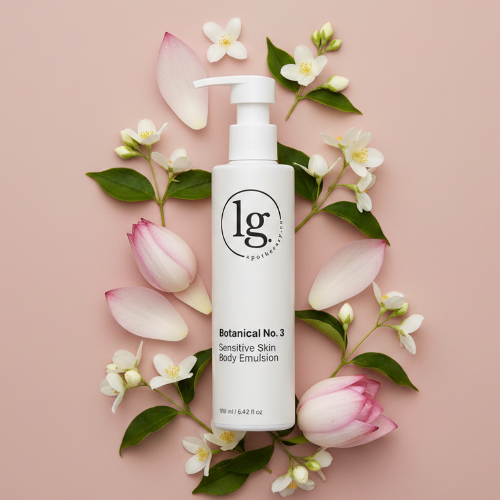 Botanical No. 3 Sensitive Skin Body Emulsion bottle surrounded by delicate white flowers and pink petals on a soft pink background, highlighting botanical skincare and clean beauty.