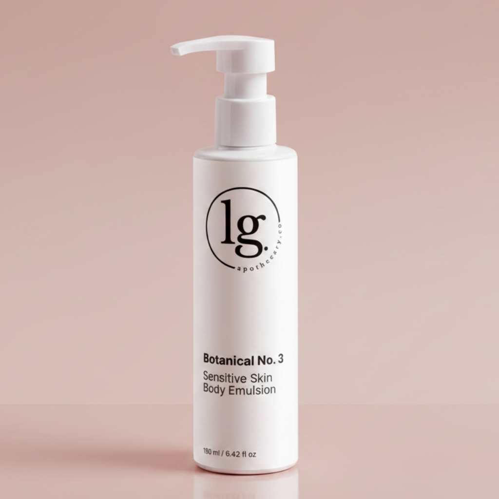 A sleek white bottle of Botanical No. 3 Sensitive Skin Body Emulsion from lg apothecary co on a soft pink background, highlighting eco-conscious luxury and botanical skincare.
