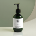 Green glass pump bottle of Botanical No. 4 Restorative Emulsion Body Lotion with minimalist white label on neutral background, highlighting botanical skincare and clean beauty.