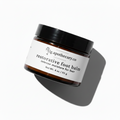 LG Apothecary Co. Restorative Foot Balm in a 4 oz amber glass jar with a black lid, featuring a clean white label