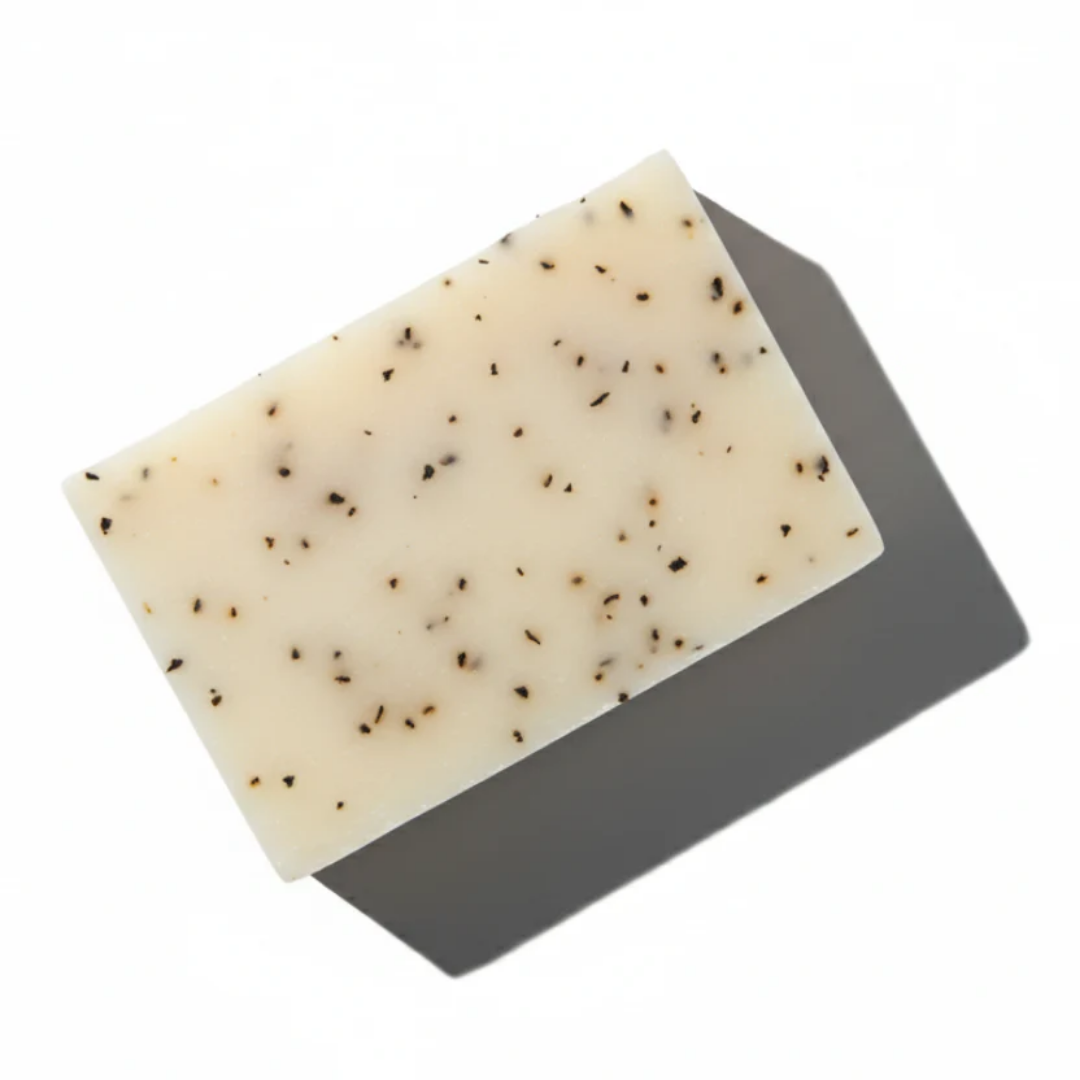 Handcrafted Peppermint Leaves botanical soap bar from LG Apothecary Co, showcasing a creamy, dense texture with visible organic peppermint leaves, resting on a clean surface.