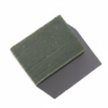 Handcrafted Pine Moss & Loofah soap bar from LG Apothecary Co. with a rich, forest-green hue and textured finish resting on a white surface.